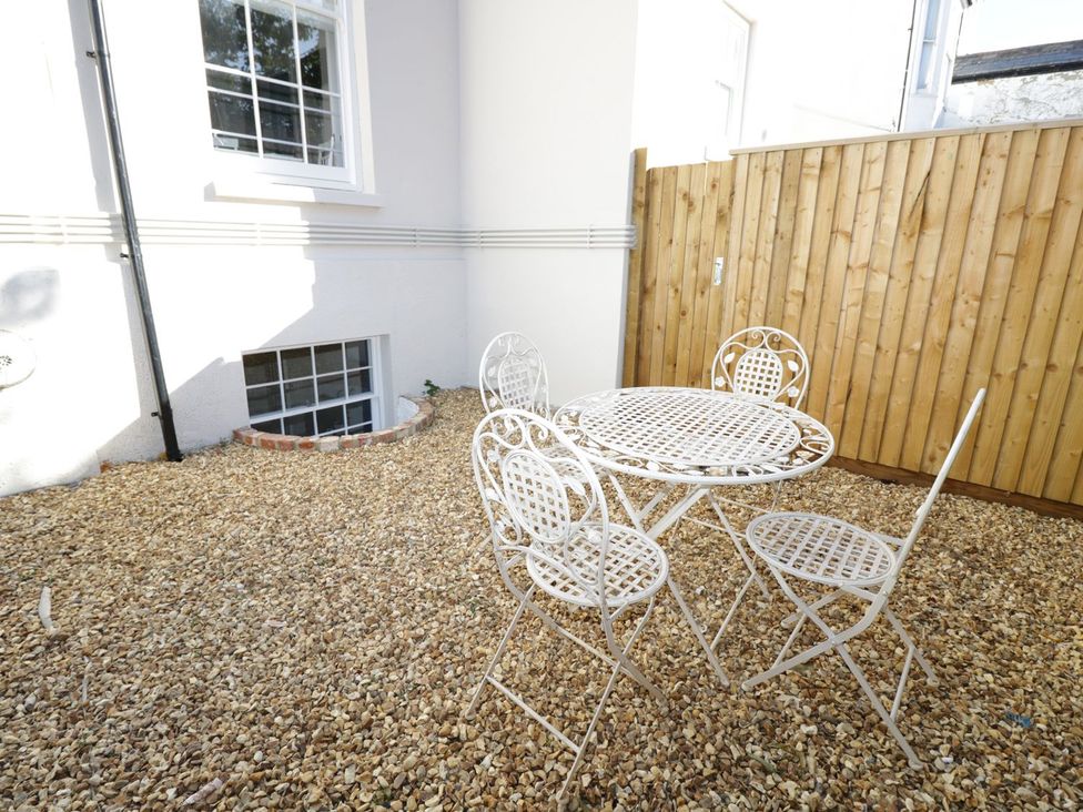 A patio area with a table and chairs at Hamilton's Studio in Ryde