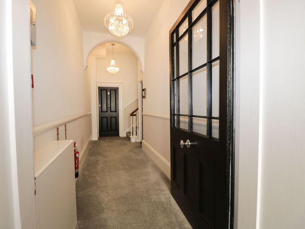 A hallway with a staircase and doors at Hamilton's Studio in Ryde