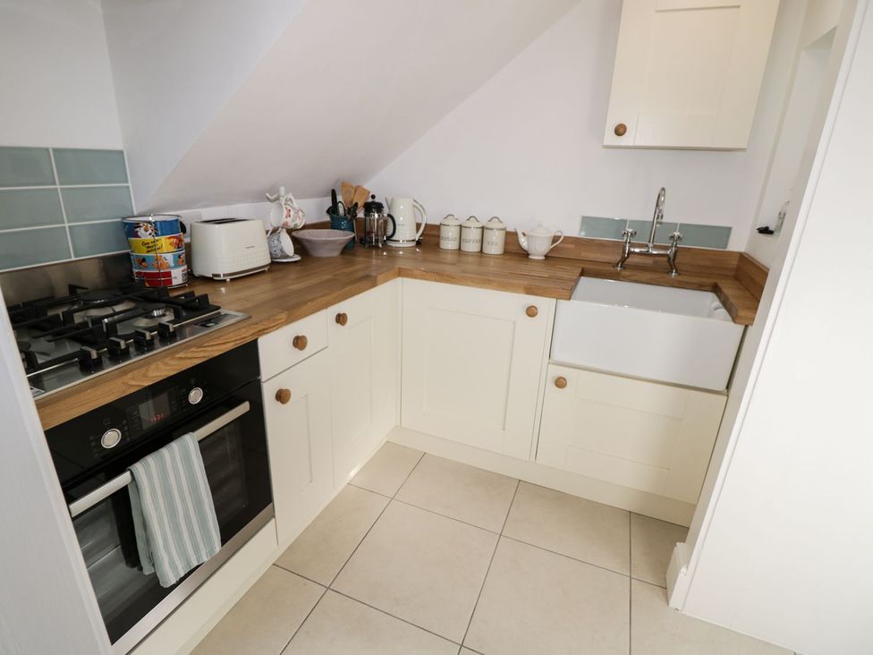 A kitchen with a sink and stove at Hamilton's Studio Ryde
