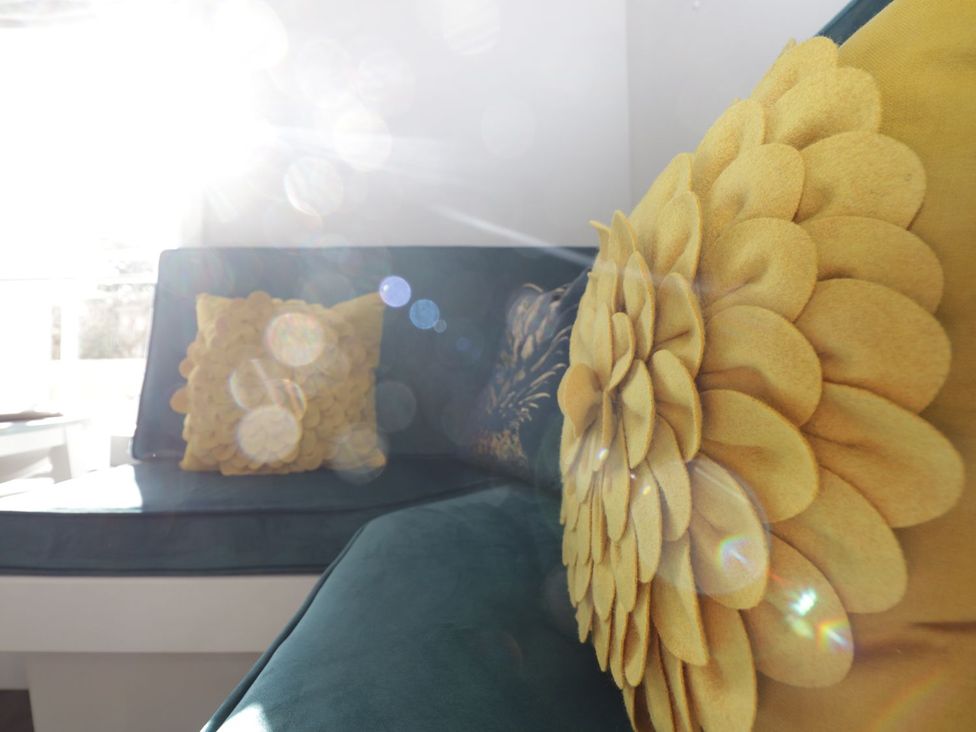 A couch with decorative pillows at Hamilton's Studio in Ryde
