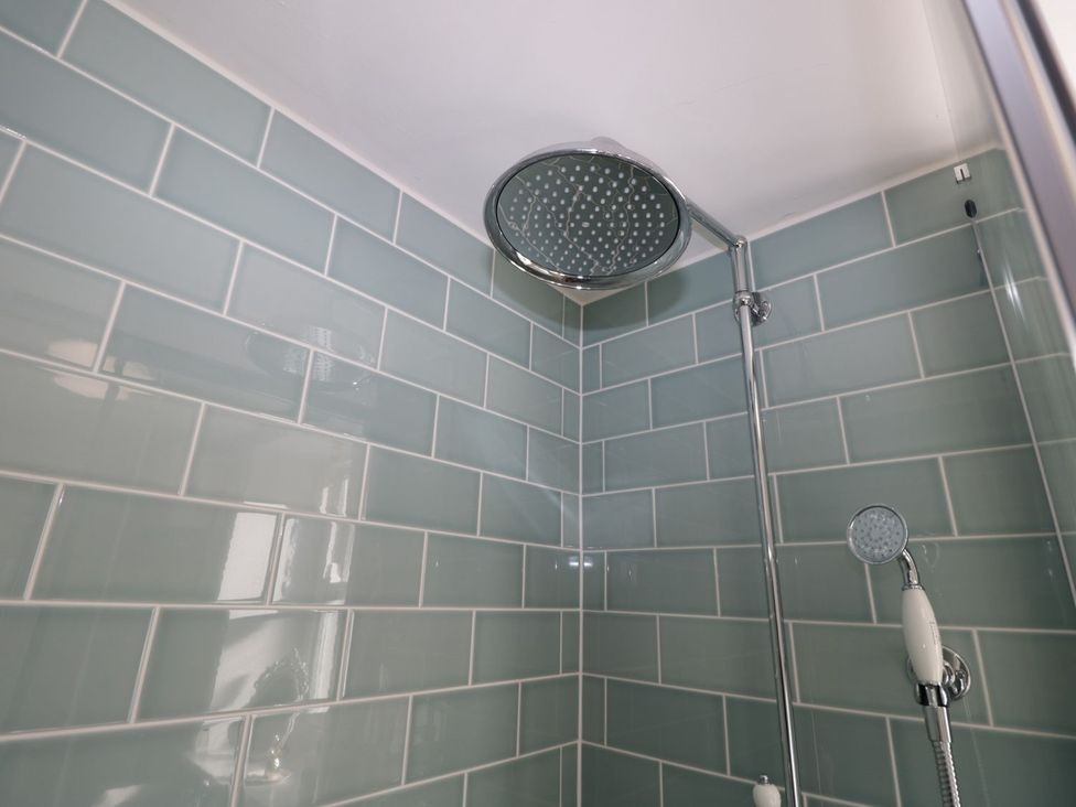 A shower with a rain shower head and handheld shower in Hamilton's Studio Ryde