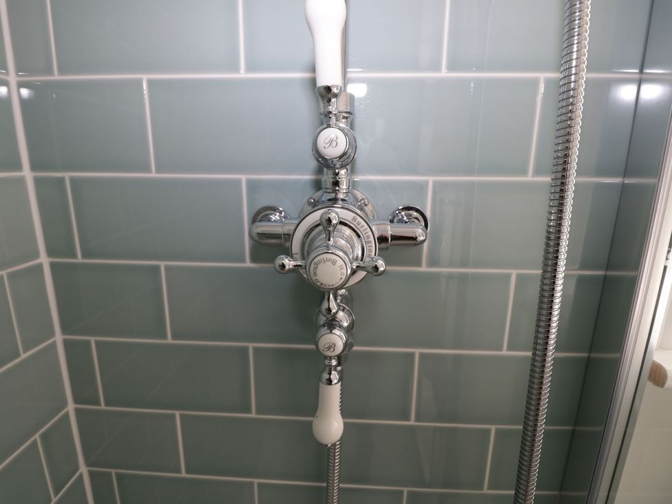 A shower valve mounted on a tiled wall at Hamilton's Studio in Ryde