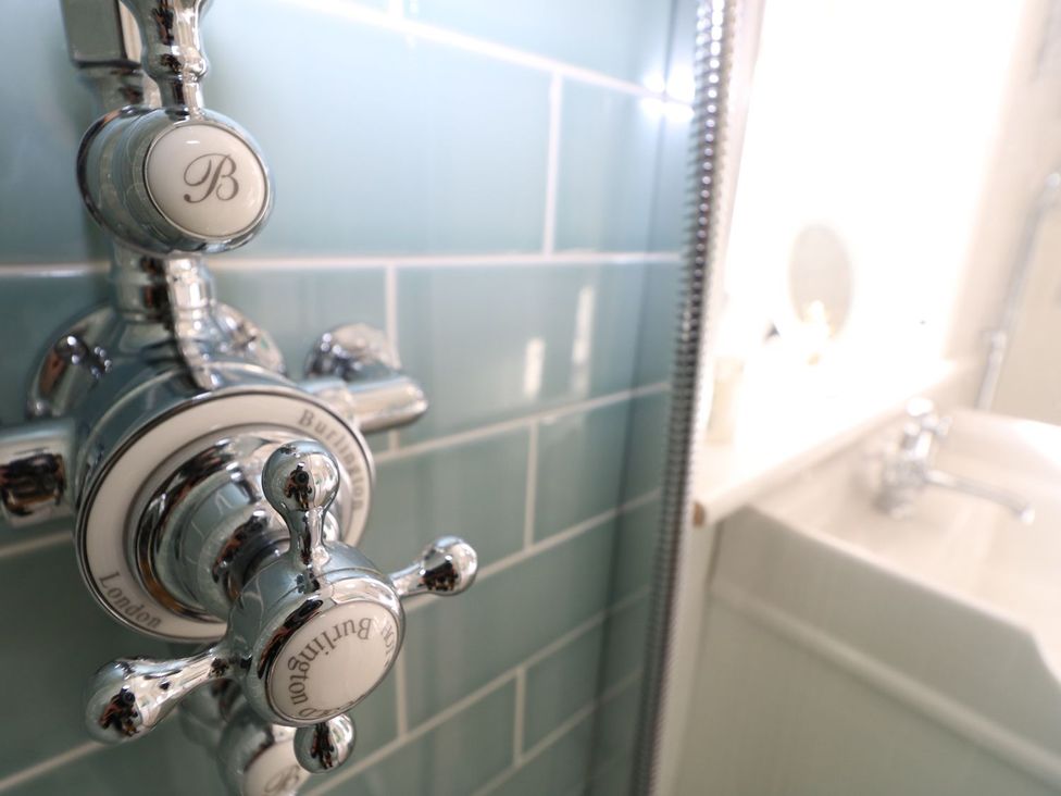 A shower control and sink in a bathroom at Hamilton's Studio Ryde