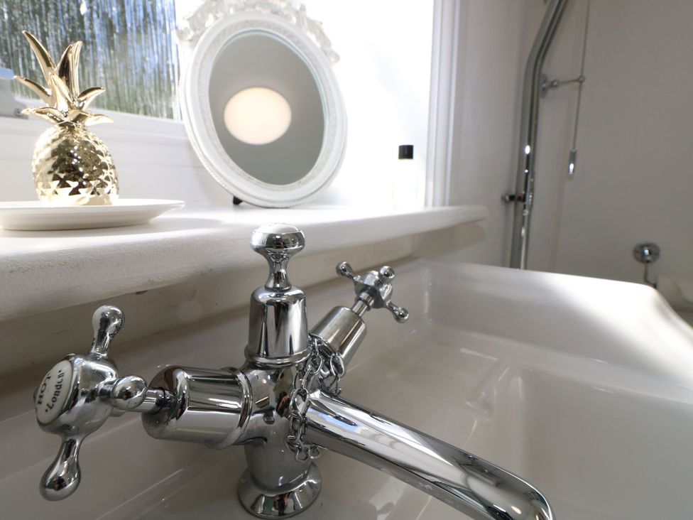 A sink with a faucet and a golden pineapple at Hamilton's Studio in Ryde