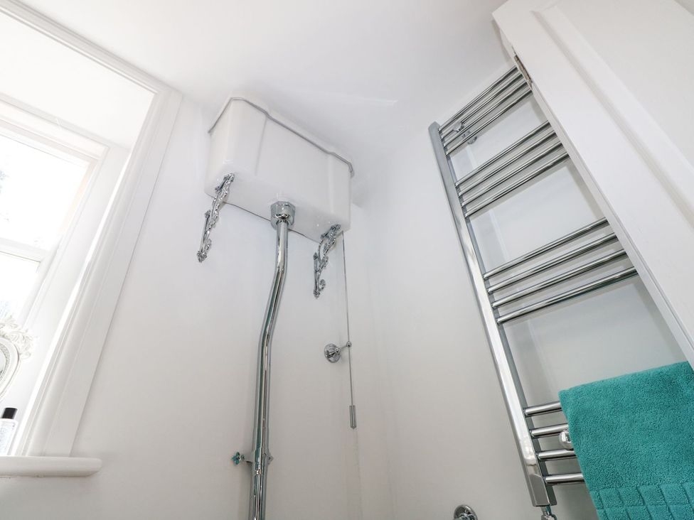 A bathroom with a toilet cistern and towel rail at Hamilton's Studio in Ryde
