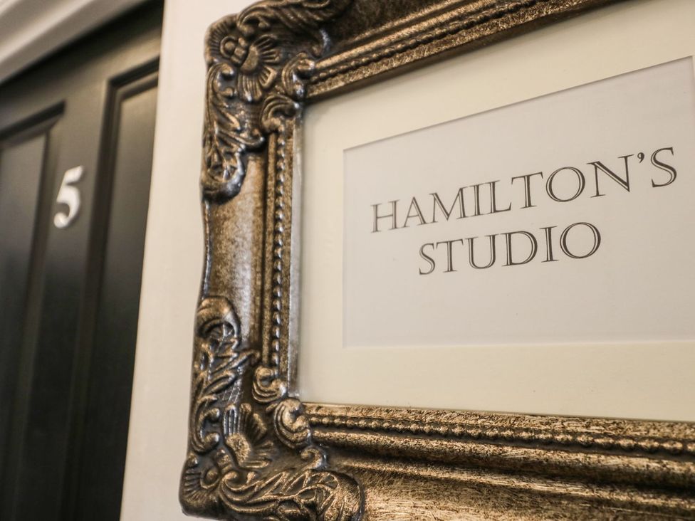 A framed sign displaying 'HAMILTON'S STUDIO' next to door number 5 at Hamilton's Studio, Ryde