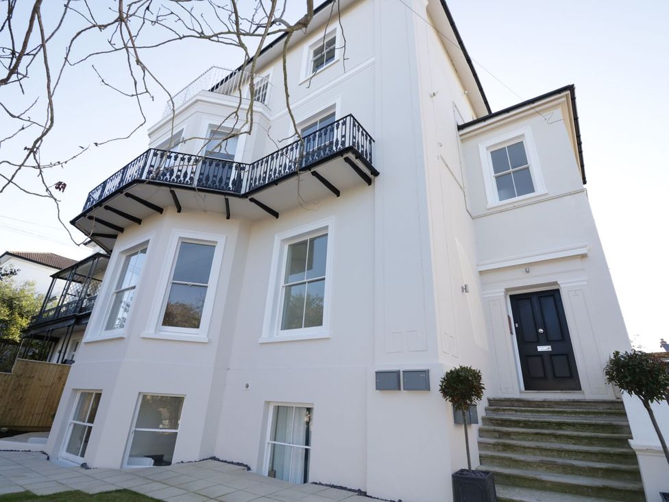 A house with a balcony and steps at Hamilton's Studio in Ryde
