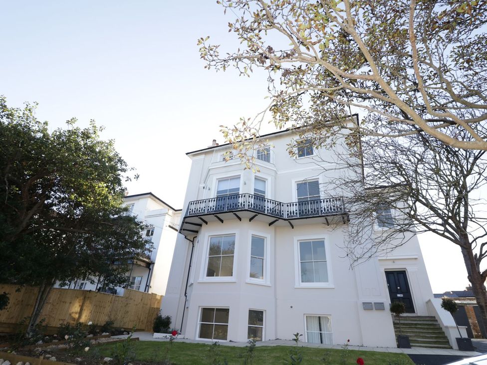 A house with a balcony and garden at Hamilton's Studio in Ryde