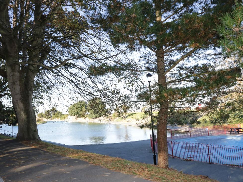 A park with trees and a body of water at Hamilton's Studio Ryde