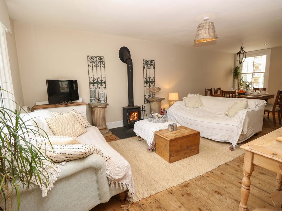 A living room with a sofa and television at Fern Cottage in Bembridge