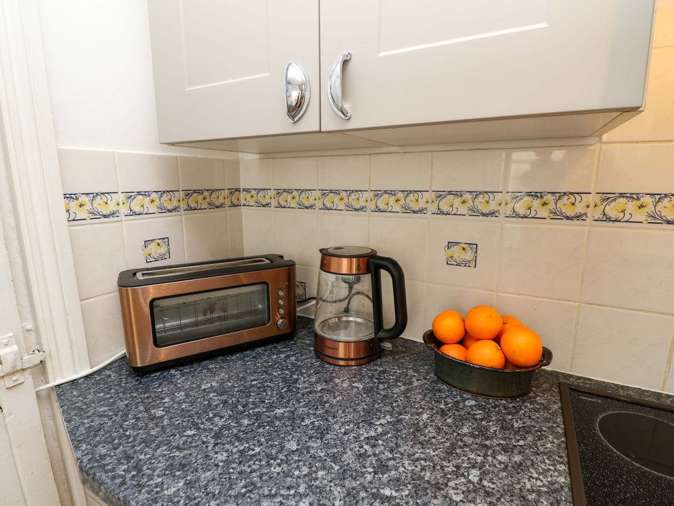 A kitchen with a toaster and kettle on the countertop at Fern Cottage in Bembridge