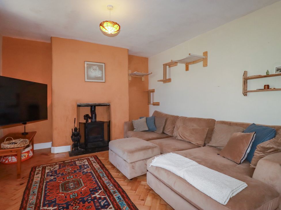 A living room with a sofa and television at 18 Tregea Terrace in Portreath