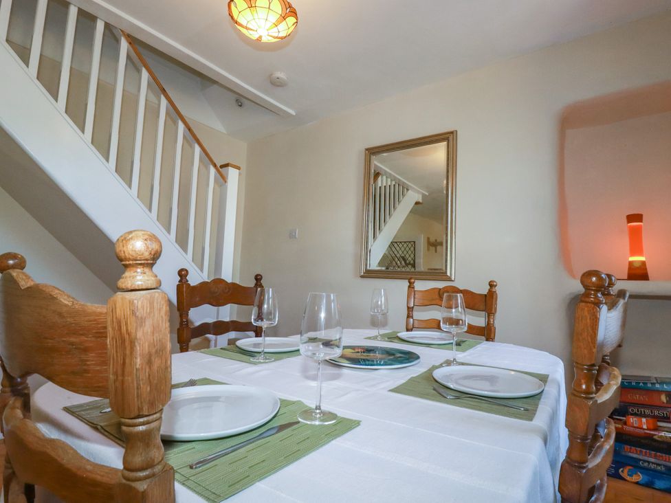 A dining room with a table set for dining at 18 Tregea Terrace in Portreath