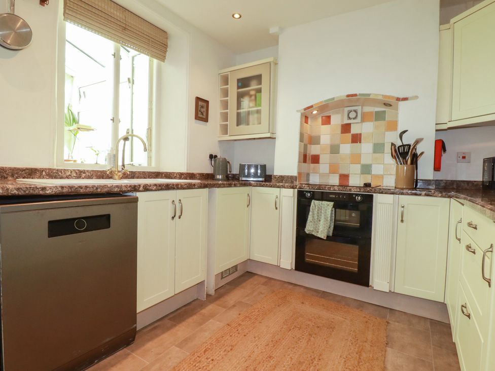 A kitchen with a sink and oven at 18 Tregea Terrace in Portreath