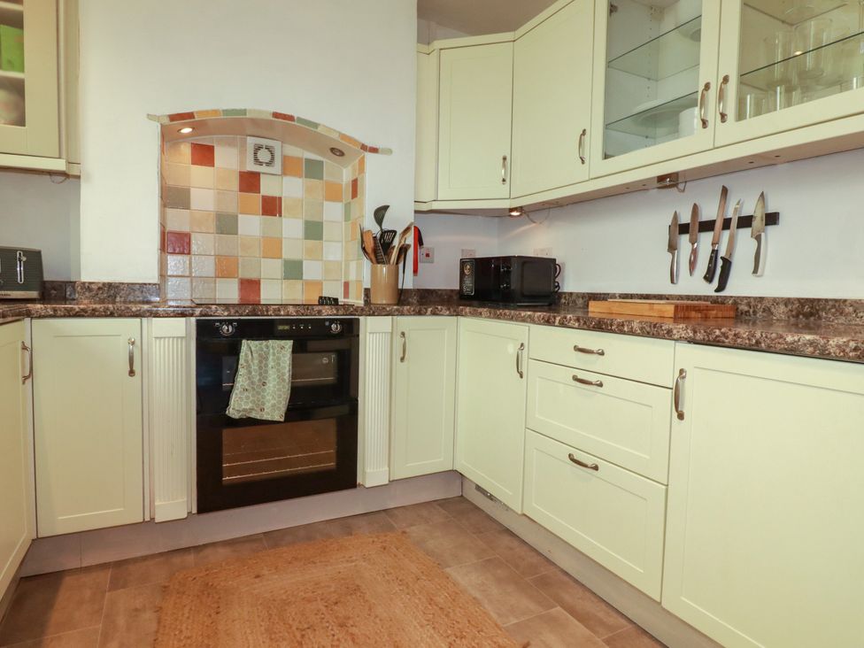 A kitchen with cabinets, countertop, oven, microwave at 18 Tregea Terrace in Portreath