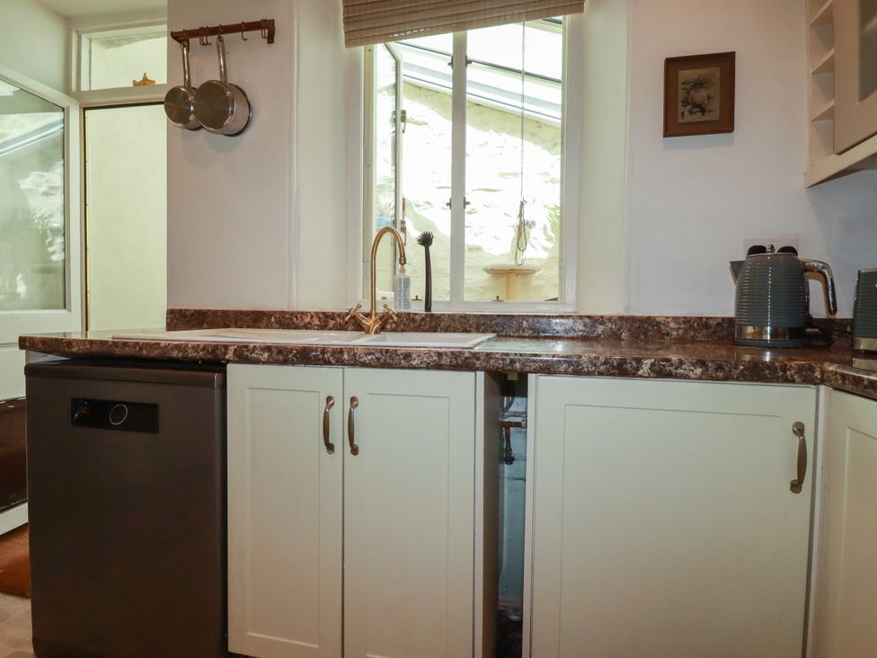 A kitchen with a sink and dishwasher at 18 Tregea Terrace in Portreath