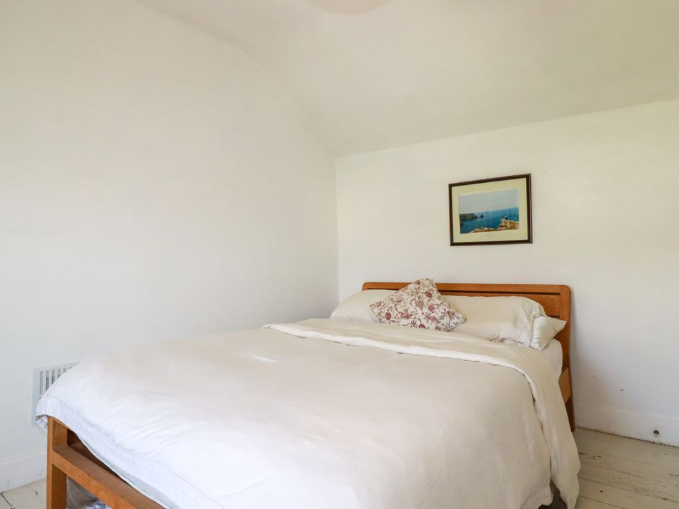 A bedroom with a bed and a picture at 18 Tregea Terrace in Portreath