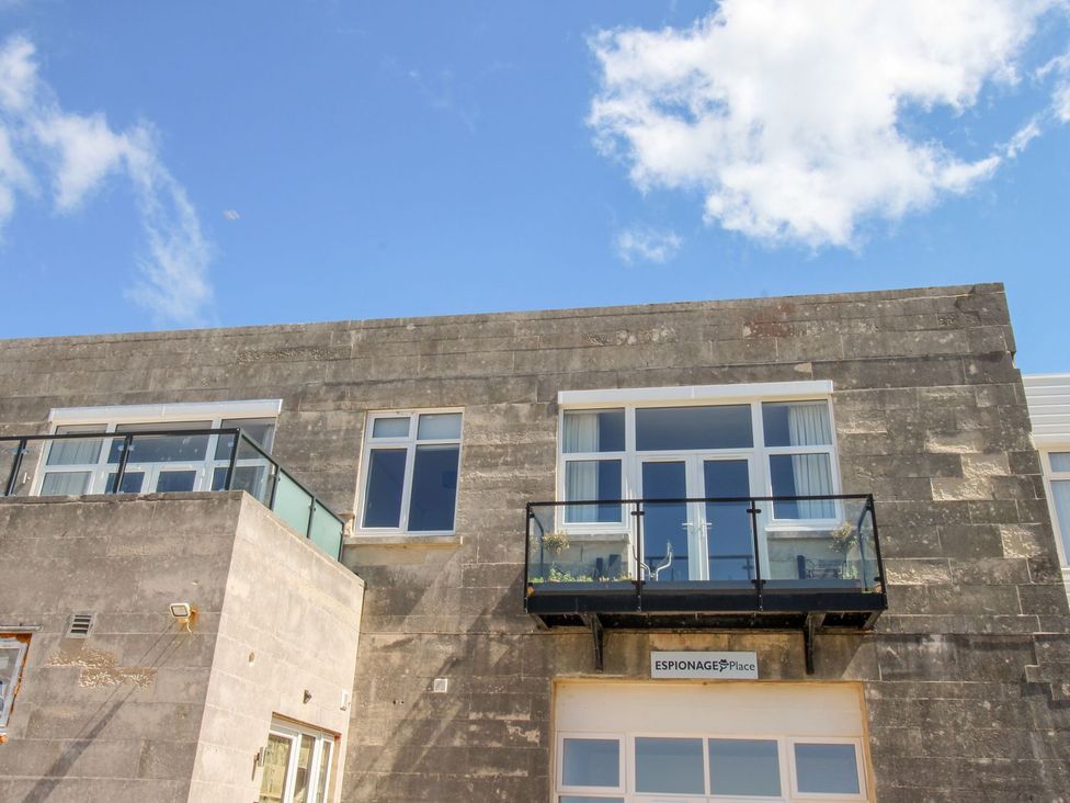 A building with a balcony and windows at Portland View in Portland Bill