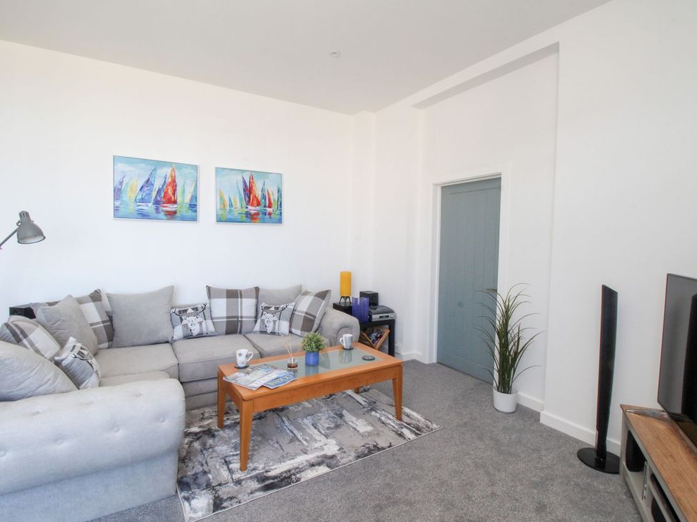 A living room with a sofa and table at Portland View in Portland Bill
