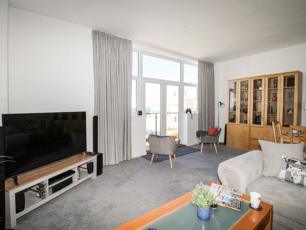 A living room with a television and a coffee table at Portland View in Portland Bill
