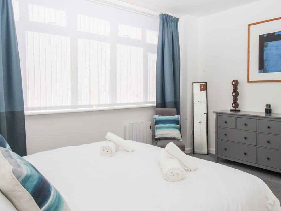 A bedroom with a bed and a mirror at Portland View in Portland Bill