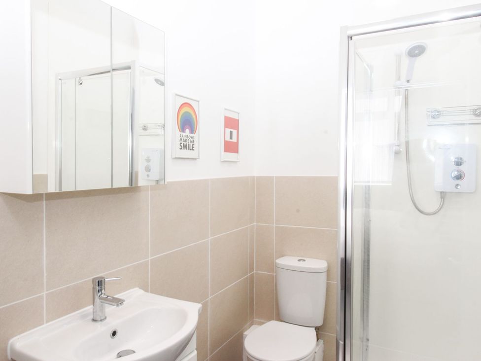 A bathroom with a sink, toilet, and shower at Portland View in Portland Bill