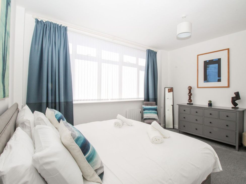 A bedroom with a bed and dressing table at Portland View in Portland Bill