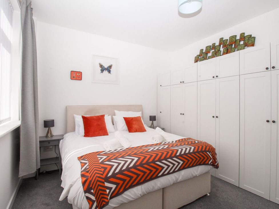 A bedroom with bed and wardrobe at Portland View in Portland Bill