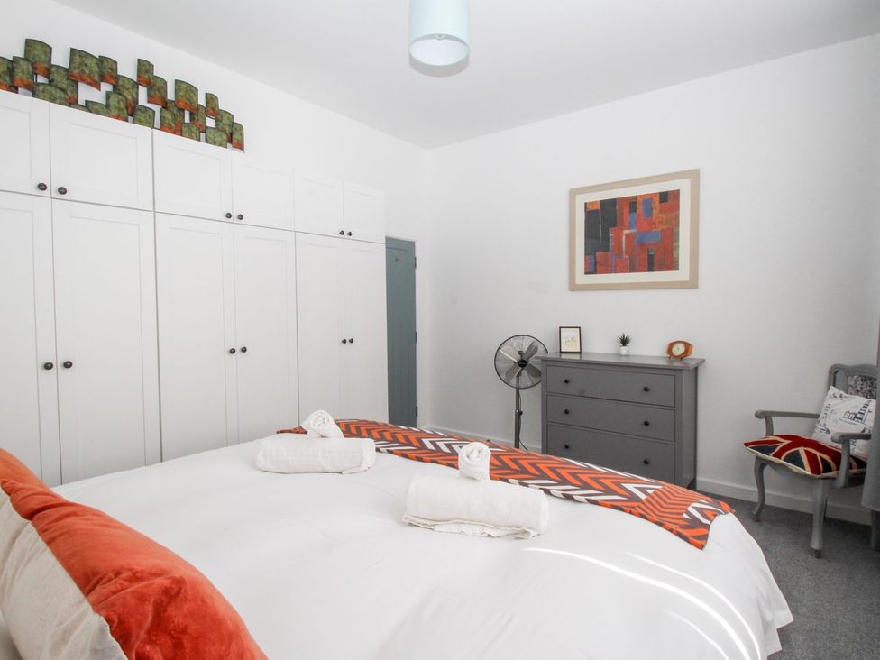 A bedroom with a bed and a wardrobe at Portland View in Portland Bill
