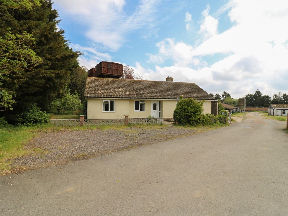 A house with trees and gravel driveway at The Lodge in 