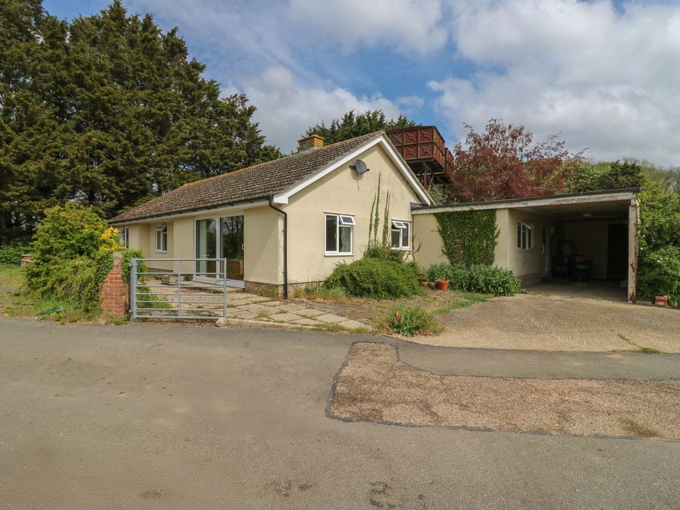 A house with a carport and garden at The Lodge in 
