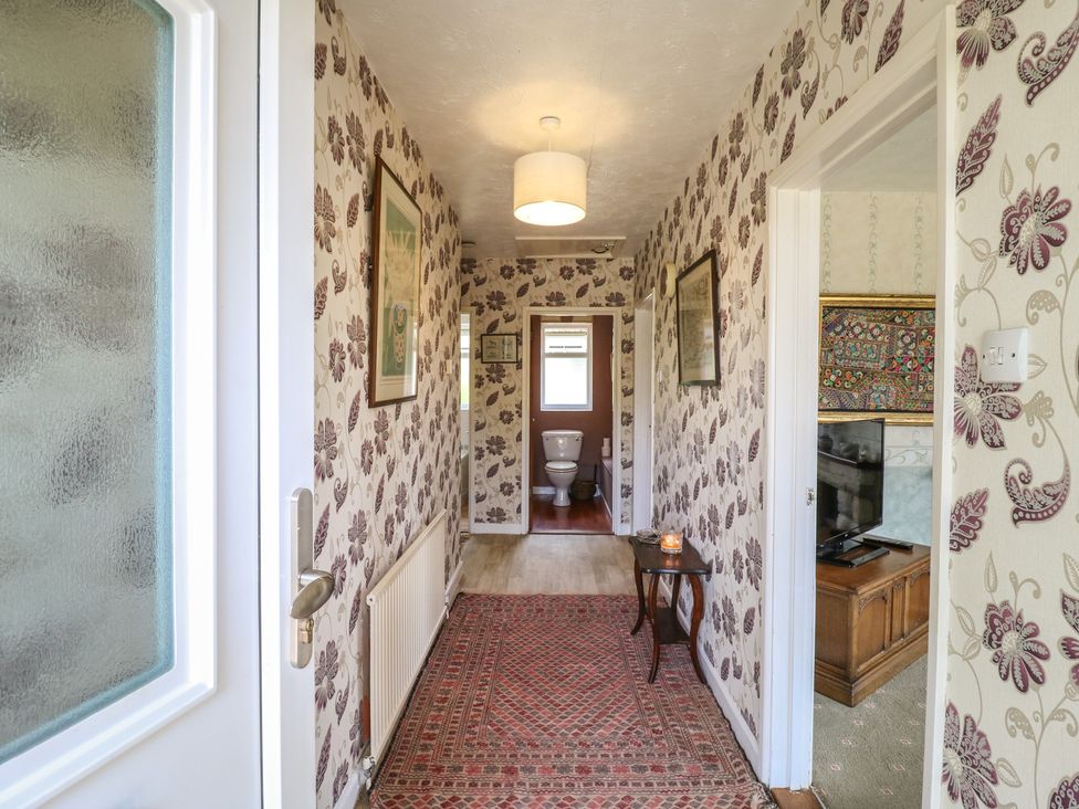 A hallway with a toilet and furniture at The Lodge in 