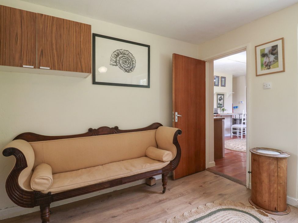 A living room with a sofa and cabinet at The Lodge 