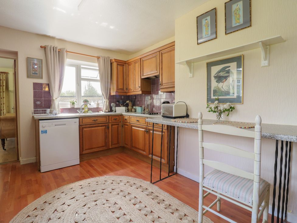 A kitchen with wooden cabinets and a countertop at The Lodge 