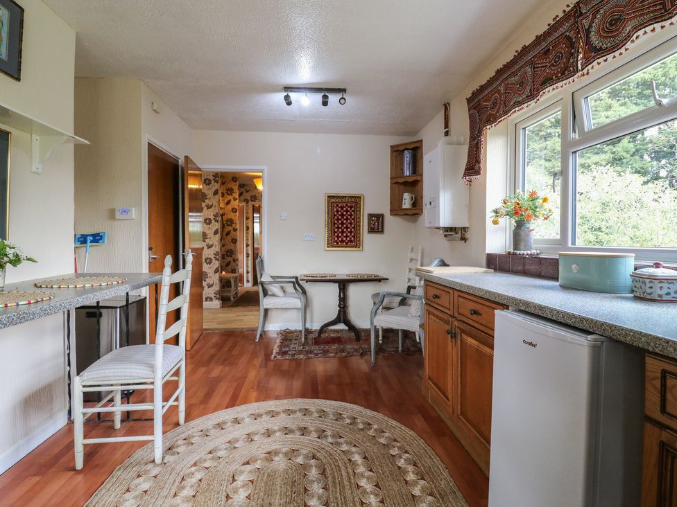 A kitchen with a table and chairs at The Lodge