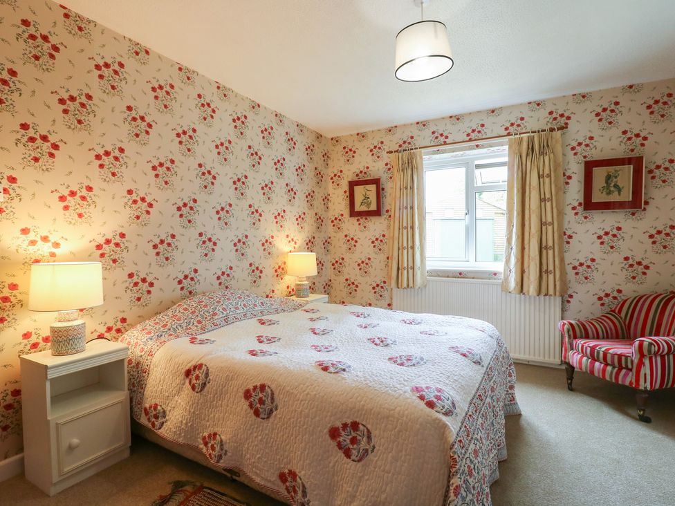 A bedroom with a bed and window at The Lodge 
