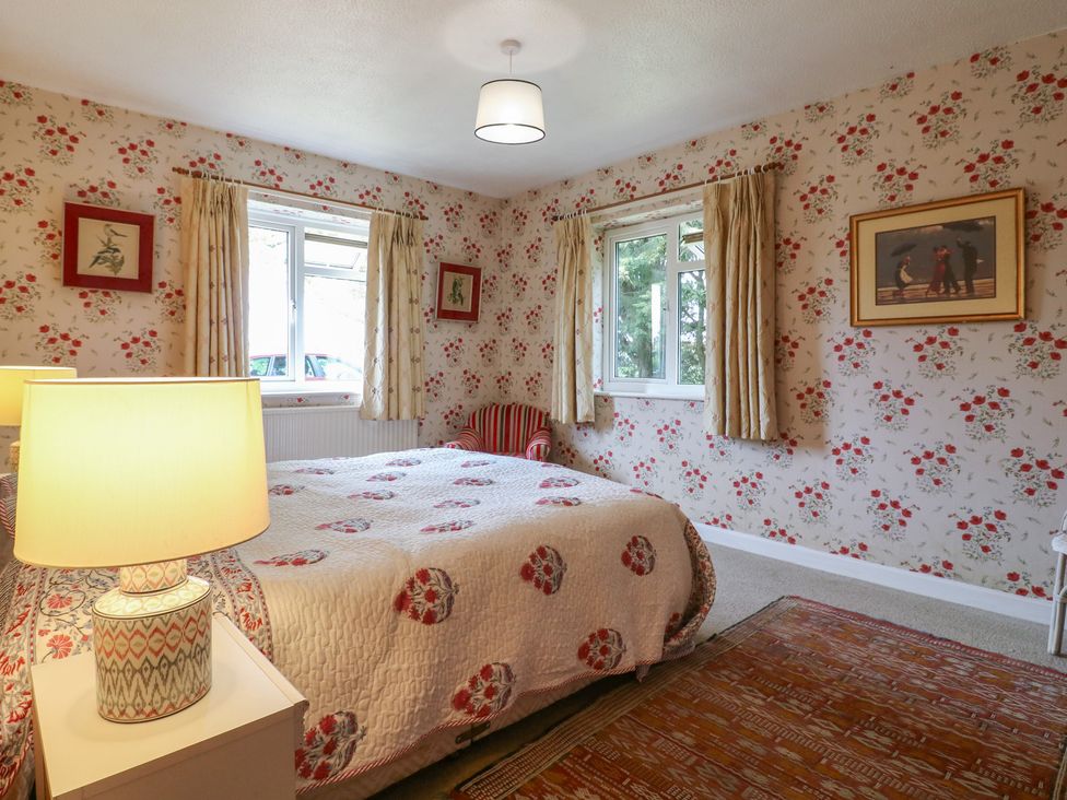 A bedroom with a bed and lamp at The Lodge 