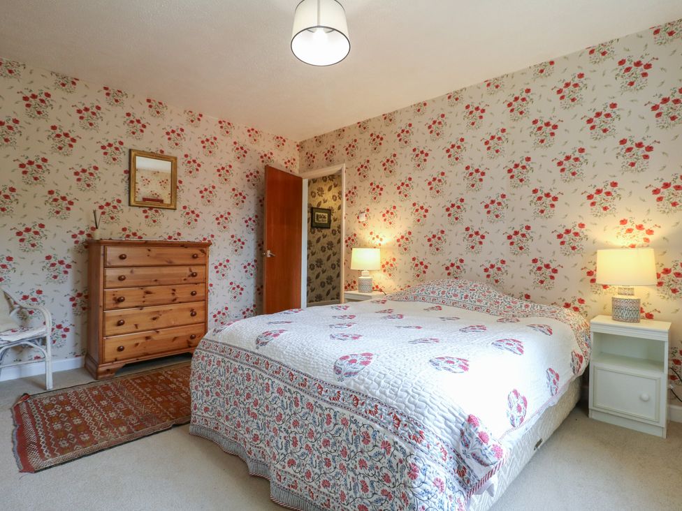 A bedroom with a bed and a dresser at The Lodge