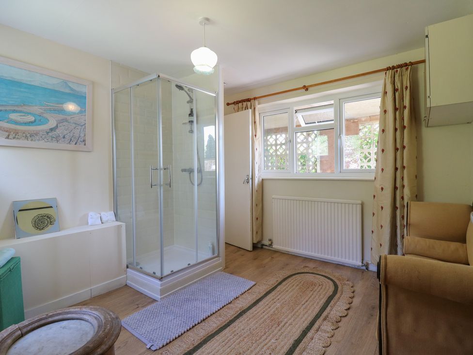 A bathroom with a shower and sink at The Lodge in 