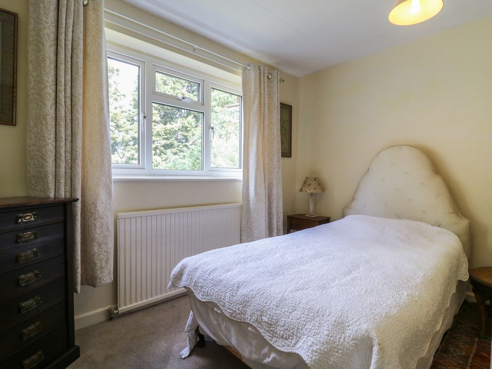 A bedroom with a bed and a window at The Lodge in 