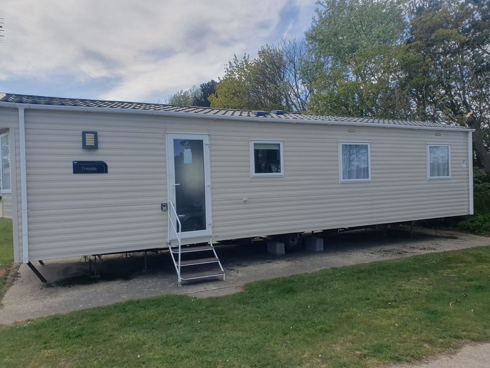 A caravan with a door and windows at Caravan 325 in Lowestoft