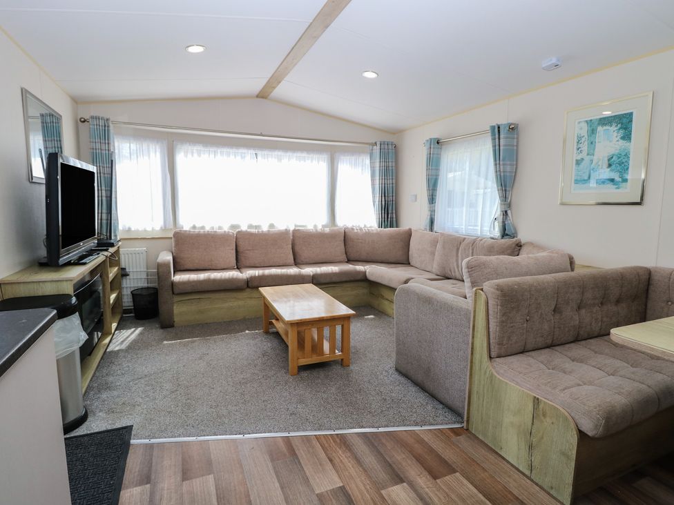 A living room with a sofa and coffee table at Caravan 325 in Corton