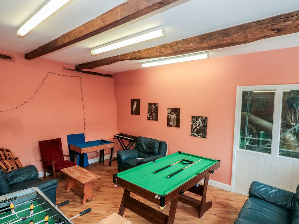 A recreation room with a pool table and foosball table at Longfords Mill, Minchinhampton