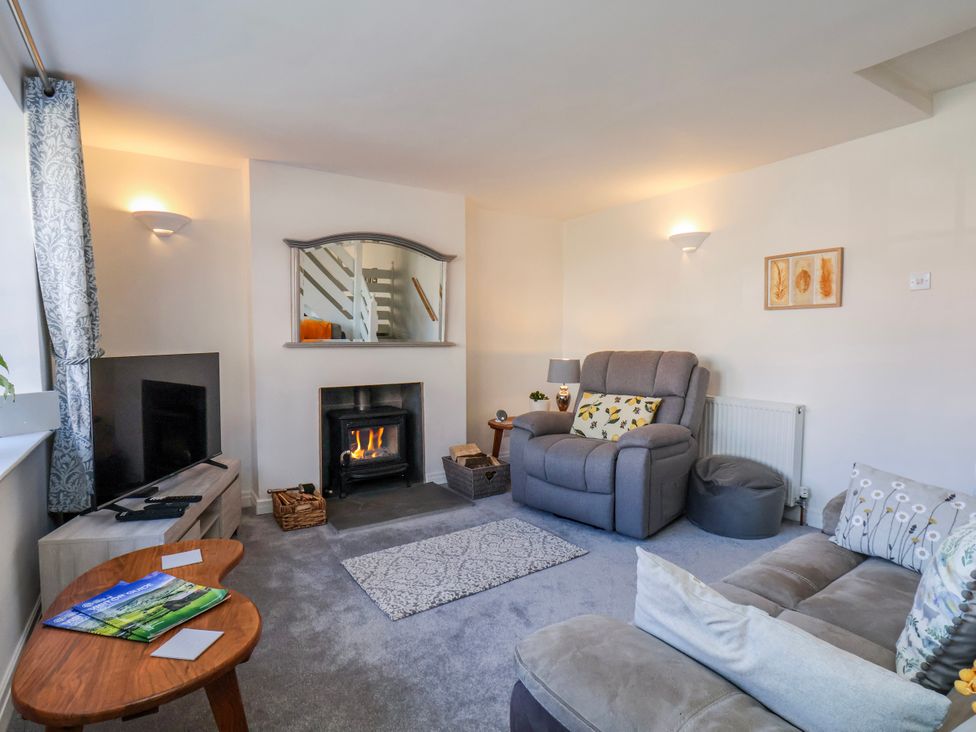 A living room with a fireplace and sofa at 1 West Ville Mews in York