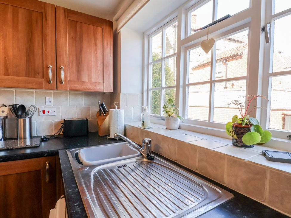 A kitchen with a sink and window at 1 West Ville Mews York