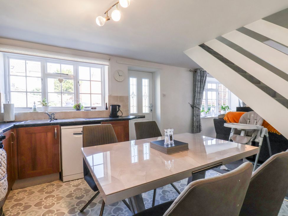 A kitchen with a dining table and chairs at 1 West Ville Mews, York