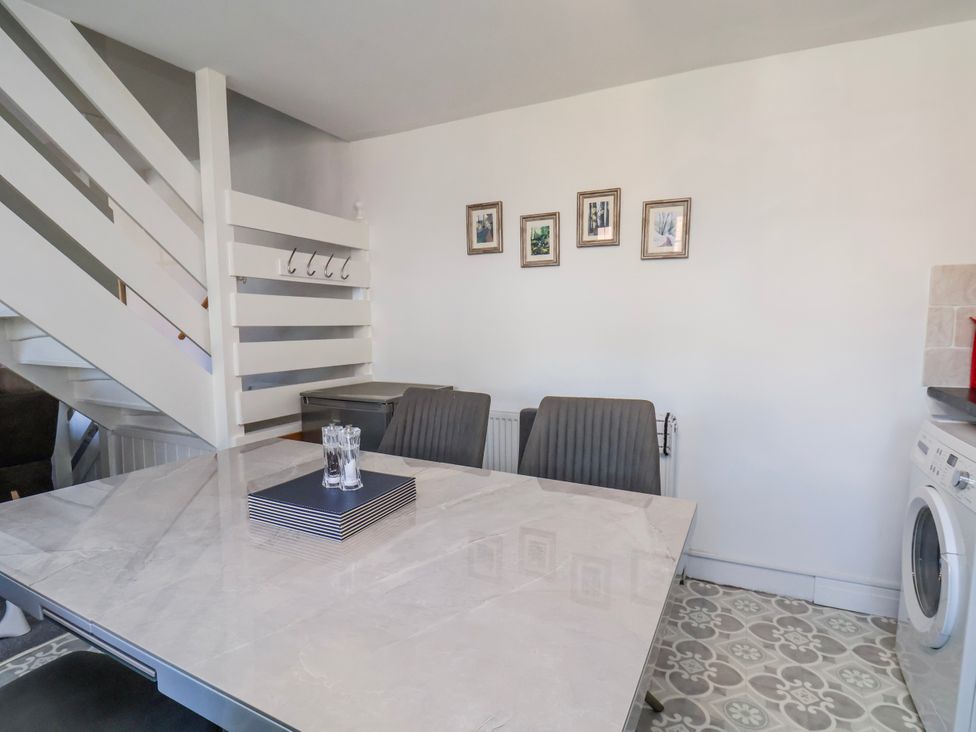 A dining room with a table and chairs at 1 West Ville Mews York