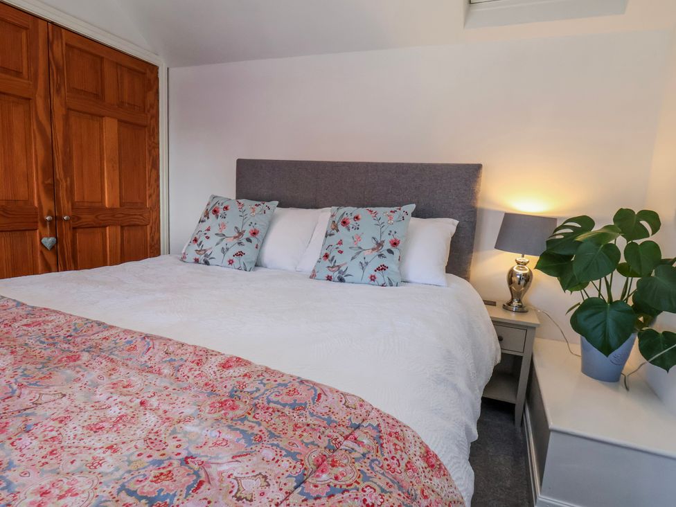 A bedroom with a bed and bedside table at 1 West Ville Mews York