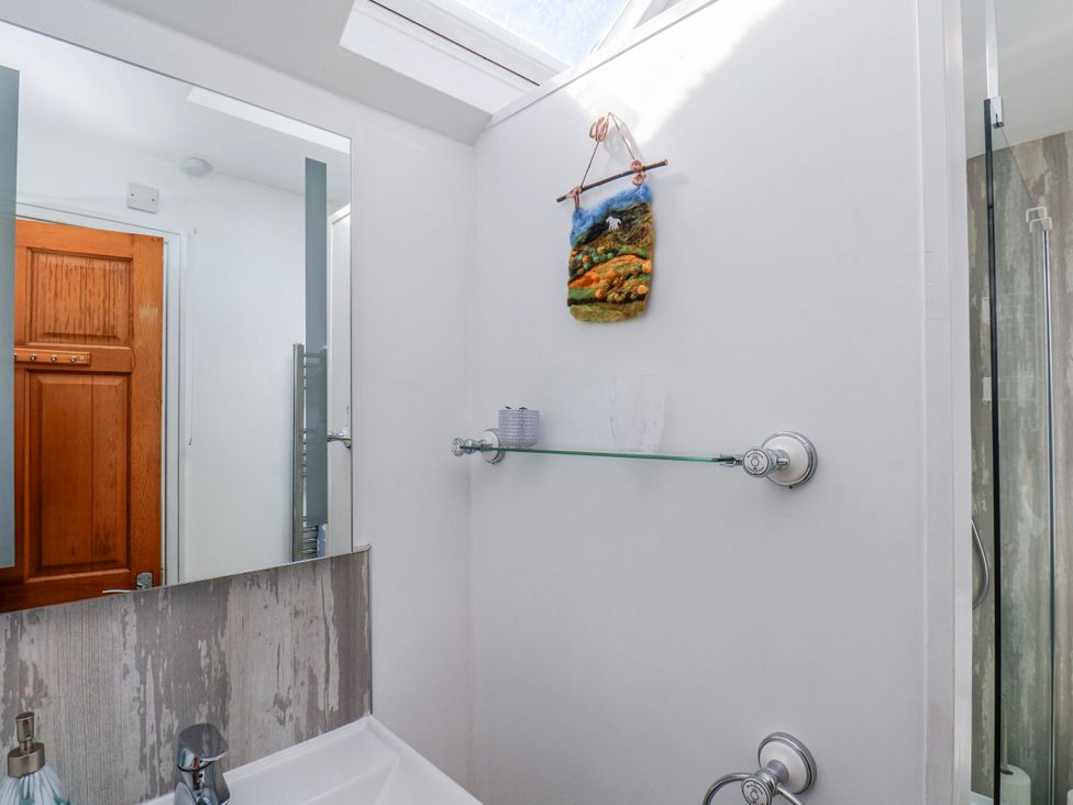 A bathroom with a shelf and mirror at 1 West Ville Mews York