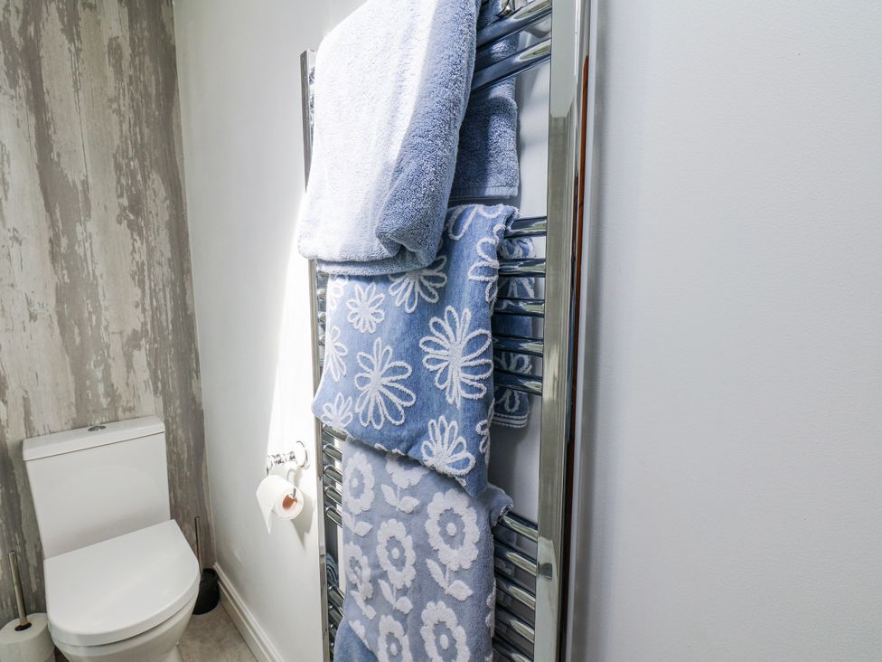 A bathroom with a towel radiator and toilet at 1 West Ville Mews York